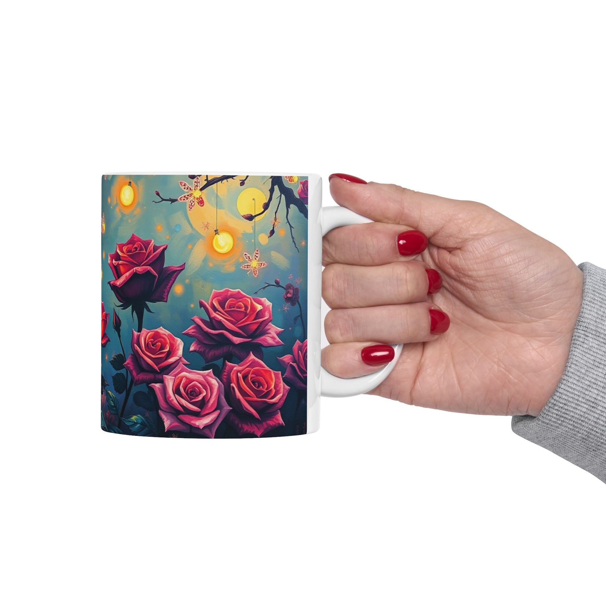 Hand holding a Twilight Rose Lantern Ceramic Mug featuring vibrant roses and whimsical glowing lights. Perfect for cozy moments.