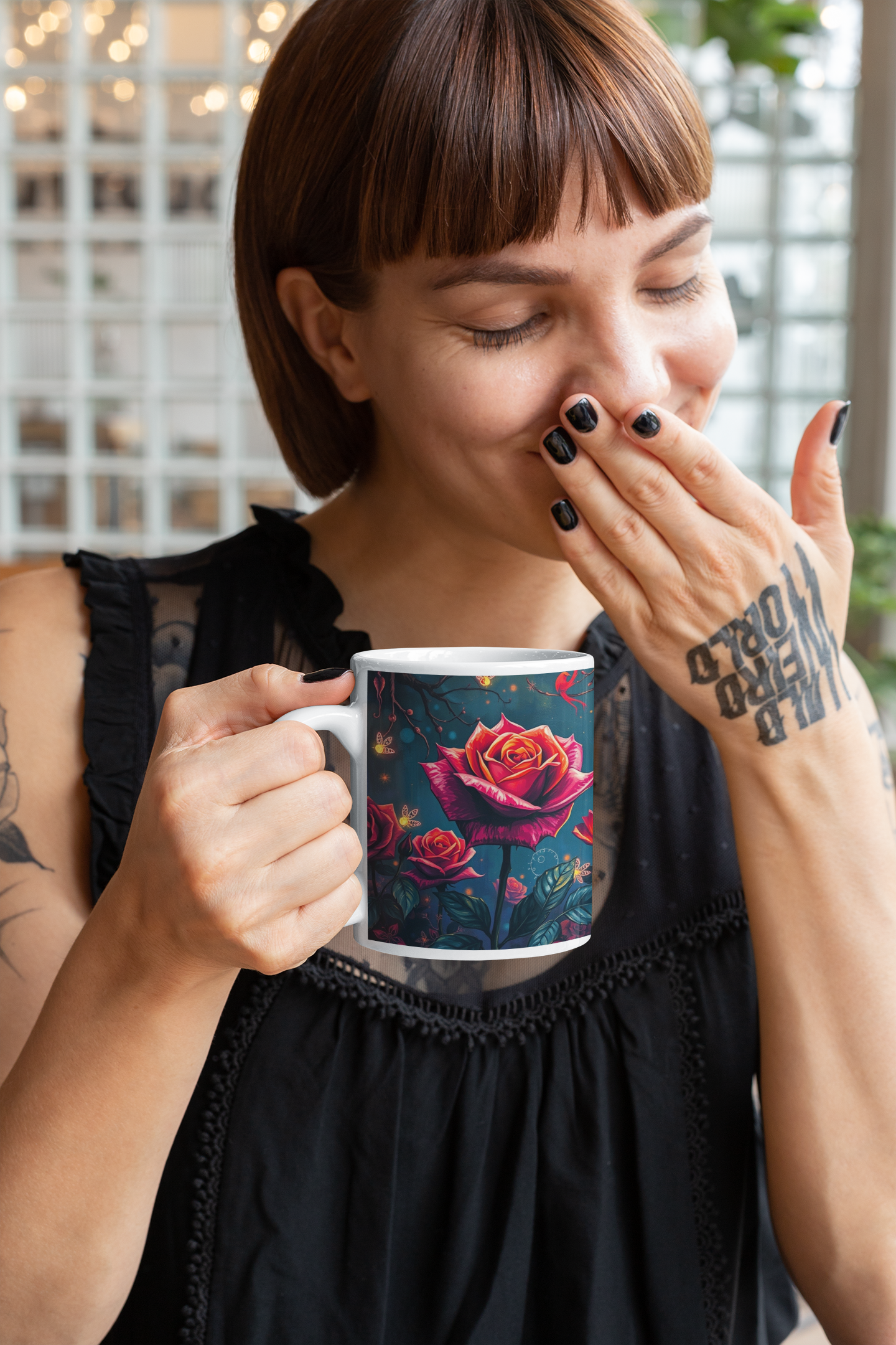 Tattooed woman joyfully holds the Twilight Rose Lantern Ceramic Mug, showcasing vibrant rose designs. Perfect for cozy moments.